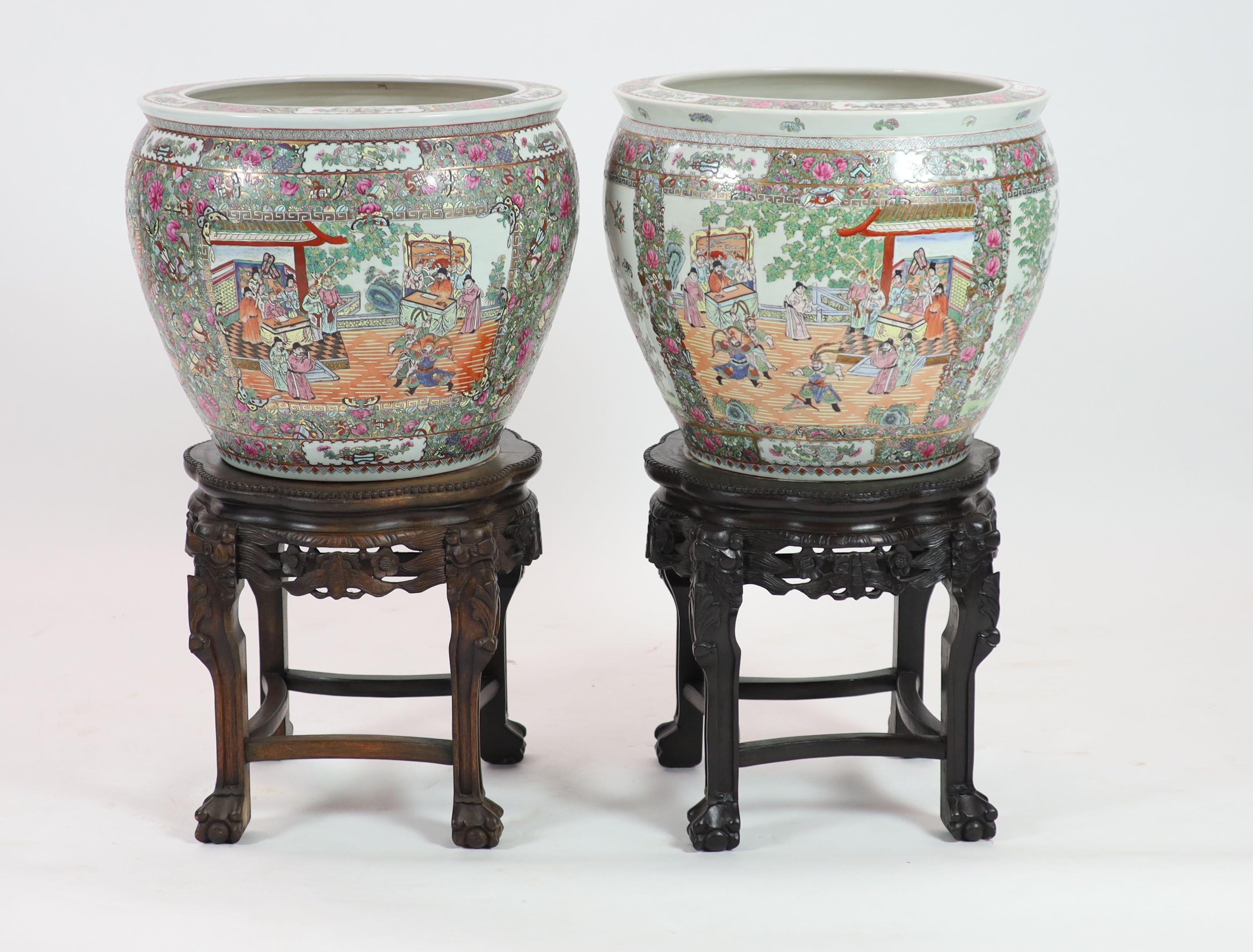 A pair of Chinese famille rose fish bowls on ebonised marble inset stands, diameter 56cm, total height 91cm